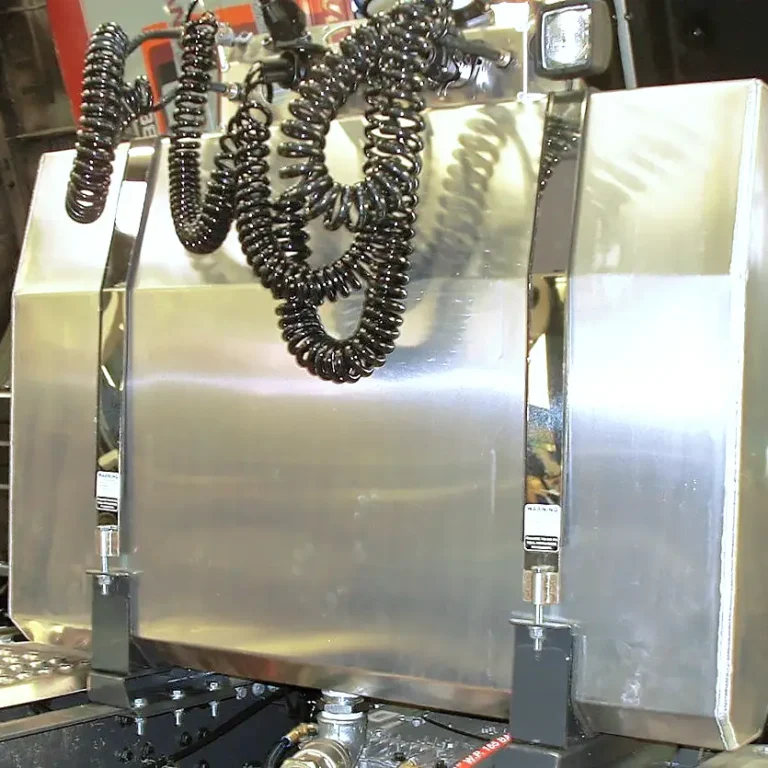 Rear of cab mounted hydraulic oil tank
